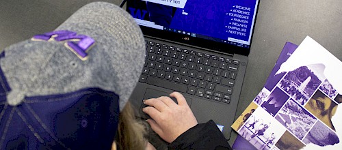 UW student completing the University 101 training on a laptop