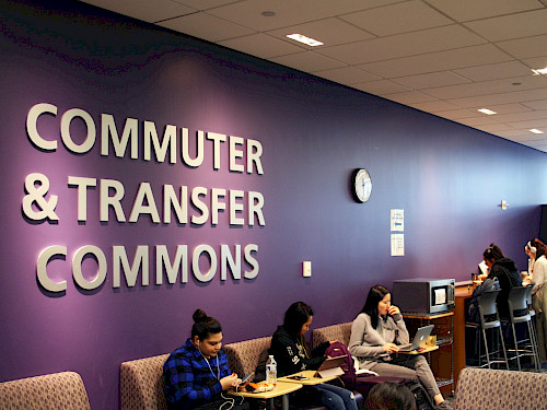 Commuter and transfer commons, with five people scattered around sitting